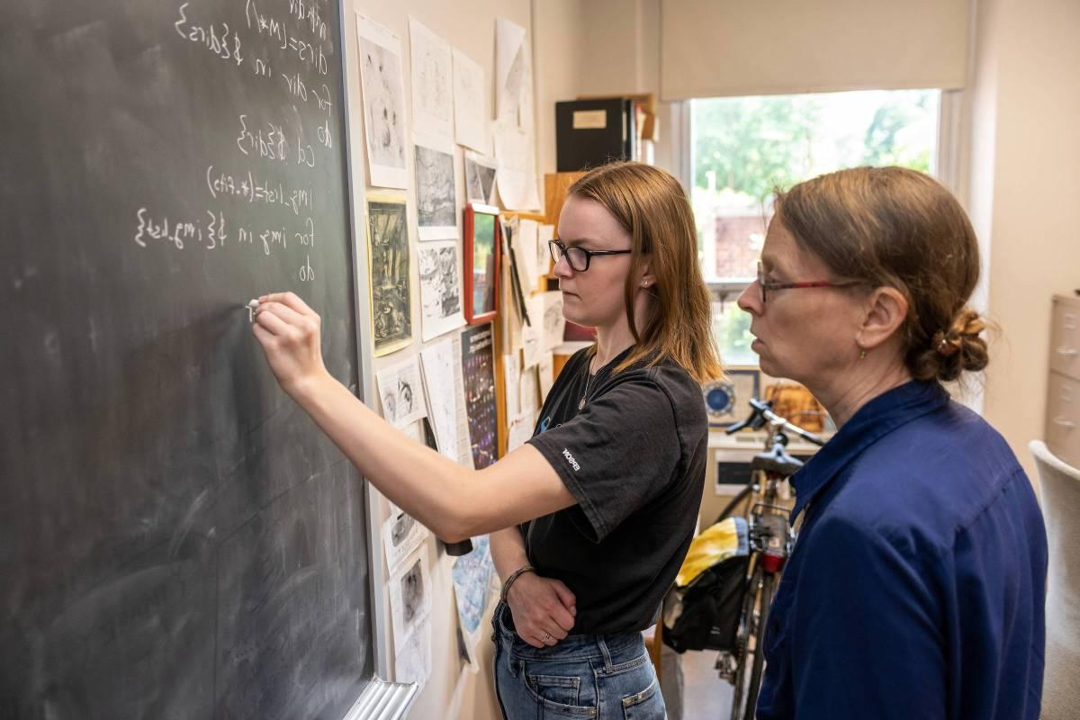 Student and professor engage in physics research